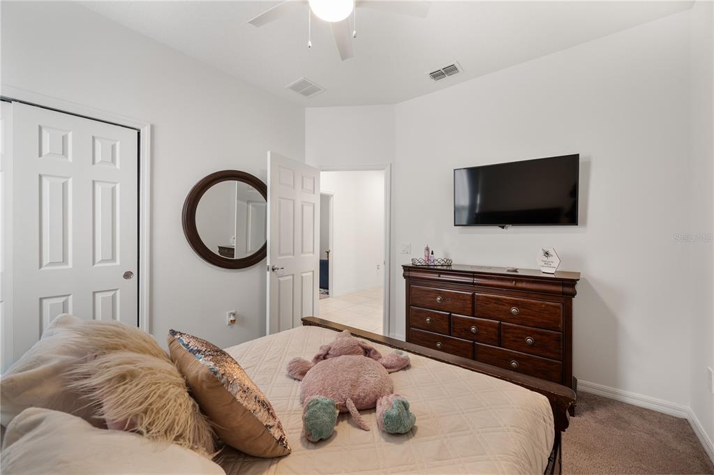 2887 Parkfield Road St. Cloud, FL 34772 - Photo 30 of 51 a bedroom with a bed and a flat screen tv