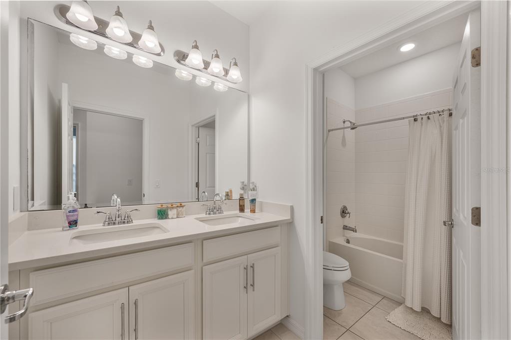 2887 Parkfield Road St. Cloud, FL 34772 - Photo 31 of 51 a bathroom with a double vanity sink mirror and toilet