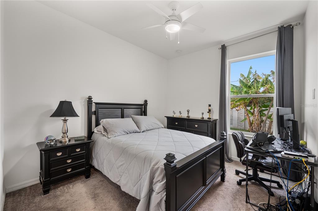 2887 Parkfield Road St. Cloud, FL 34772 - Photo 33 of 51 a bedroom with a bed and a table