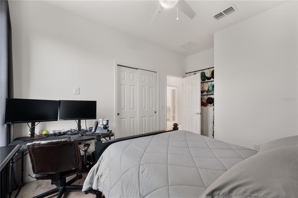 2887 Parkfield Road St. Cloud, FL 34772 - Photo 34 of 51 a bedroom with a bed and a computer on the desk