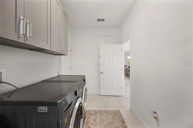 a living room with furniture floor to ceiling window and wooden floor