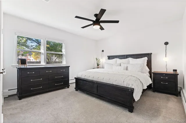 a bedroom with a bed window and a ceiling fan