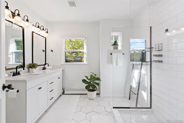 a spacious bathroom with a double vanity sink and a mirror