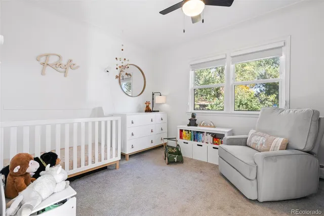 a bedroom with furniture and a large window