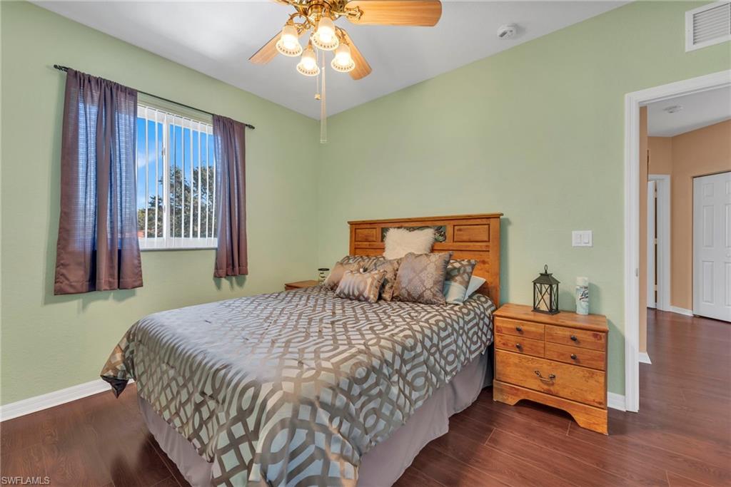 1966 Par Drive Naples, FL 34120 - Photo 14 of 32 Bedroom with dark wood-type flooring and a ceiling fan