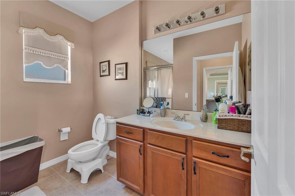 1966 Par Drive Naples, FL 34120 - Photo 18 of 32 Full bath with a shower with curtain, vanity, and light tile patterned flooring