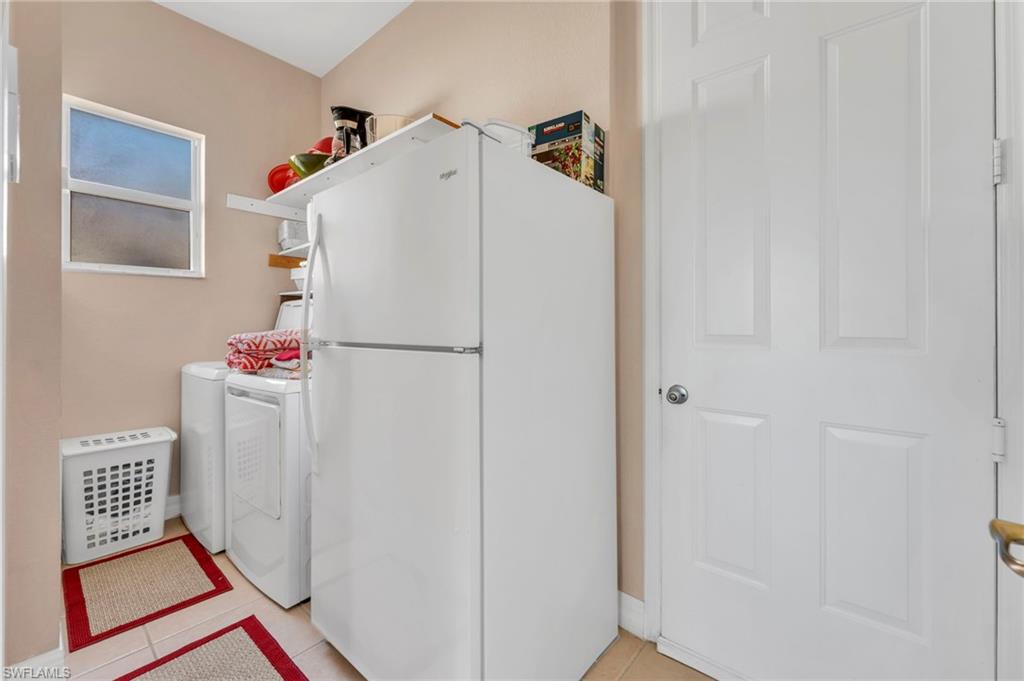 1966 Par Drive Naples, FL 34120 - Photo 19 of 32 Laundry area with light tile patterned floors and independent washer and dryer