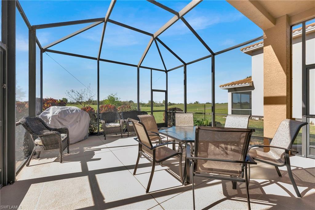 1966 Par Drive Naples, FL 34120 - Photo 21 of 32 View of patio featuring a sunroom, outdoor dining space, a lanai, and a grill