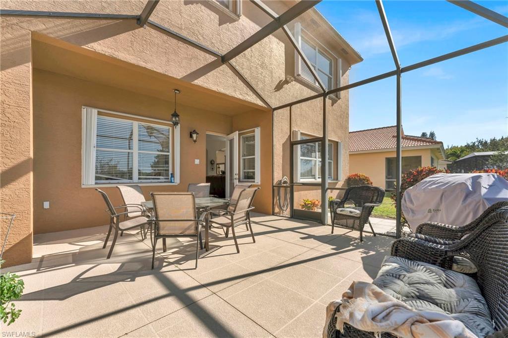 1966 Par Drive Naples, FL 34120 - Photo 22 of 32 View of patio with a sunroom, outdoor dining space, a lanai, and grilling area