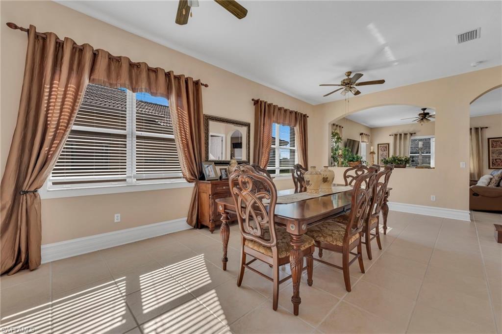 1966 Par Drive Naples, FL 34120 - Photo 6 of 32 Dining room featuring arched walkways, light tile patterned floors, and a ceiling fan