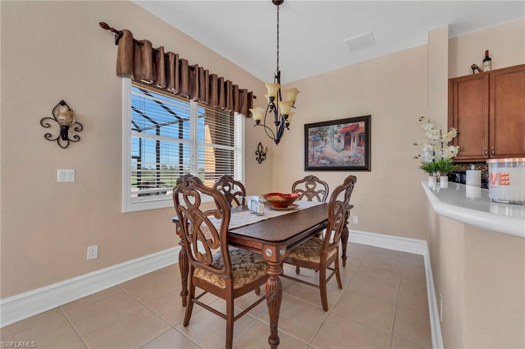 1966 Par Drive Naples, FL 34120 - Photo 8 of 32 Dining space with a chandelier and light tile patterned flooring