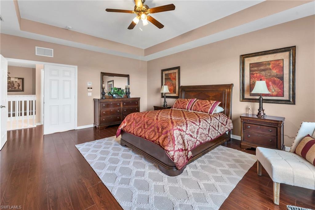 1966 Par Drive Naples, FL 34120 - Photo 10 of 32 Bedroom featuring a raised ceiling, dark wood-style floors, and a ceiling fan