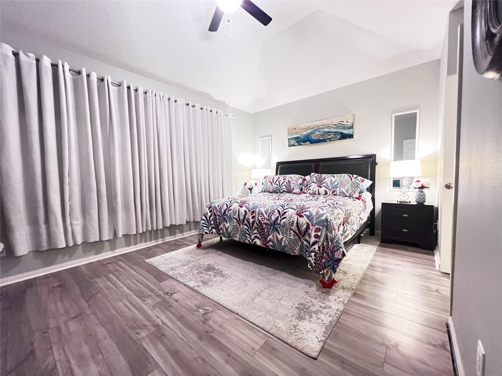 14420 Walters Road, Unit 24 Houston, TX 77014 - Photo 11 of 15 a bedroom with a bed lamp and a large window