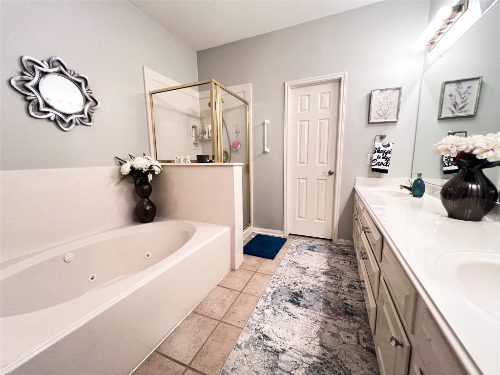 14420 Walters Road, Unit 24 Houston, TX 77014 - Photo 12 of 15 a bathroom with a tub sink and mirror