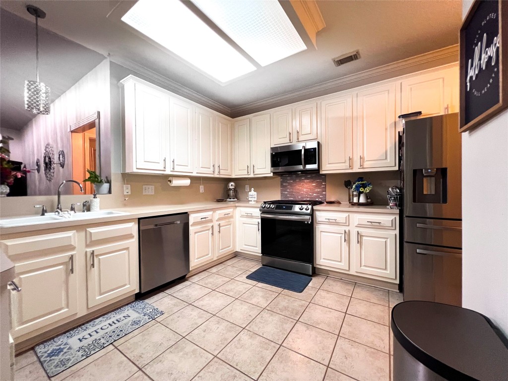 14420 Walters Road, Unit 24 Houston, TX 77014 - Photo 9 of 15 a kitchen with a sink a counter top space appliances and cabinets