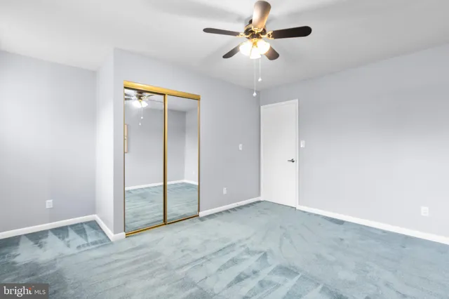 a bathroom with a granite countertop toilet sink and mirror