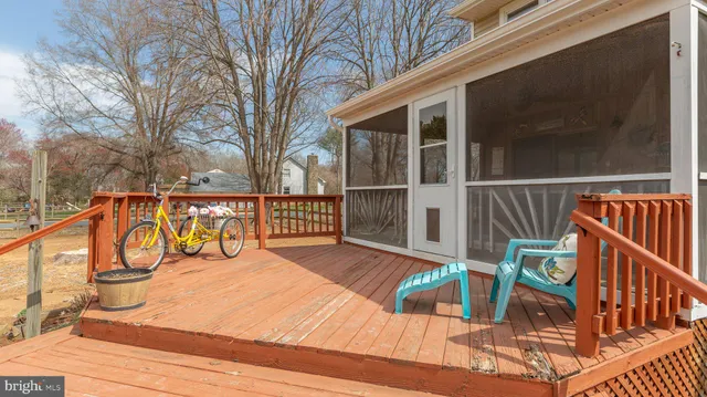 a wooden pier with boats in front of lake