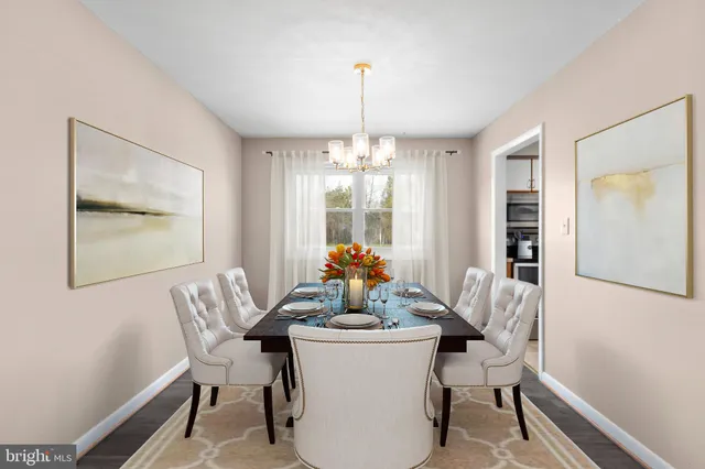 a view of a dining room with furniture and chandelier