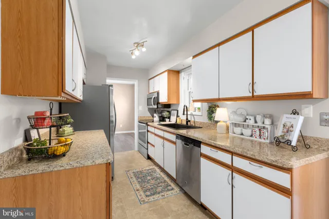 a kitchen with sink cabinets and window