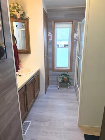 a bathroom with a sink a toilet and a mirror