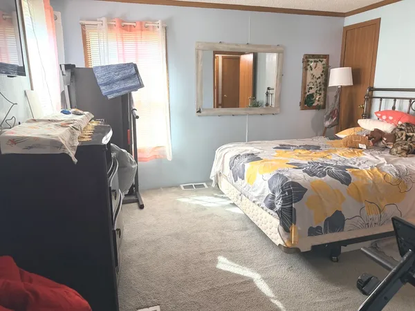 a bedroom with a bed and window