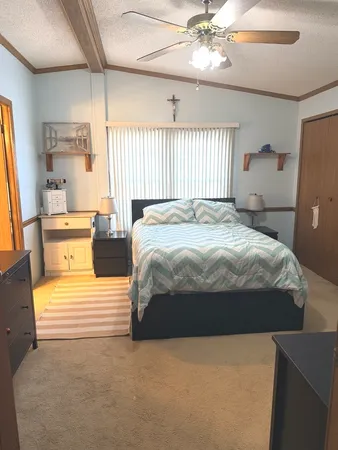 a bedroom with a bed and window