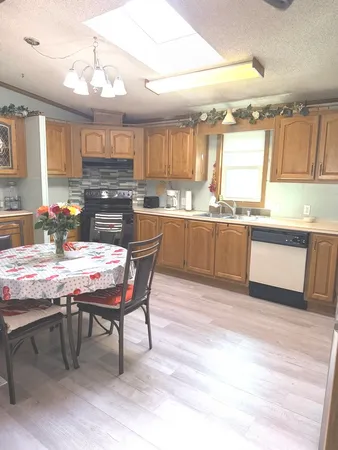 a kitchen with a table chairs stove and kitchen island