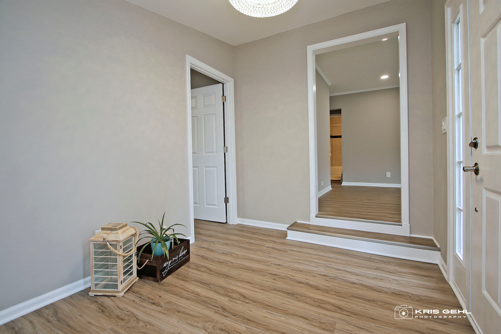 2101 Old Elm Road Lindenhurst, IL 60046 - Photo 4 of 19 an empty room with wooden floor mirror and windows