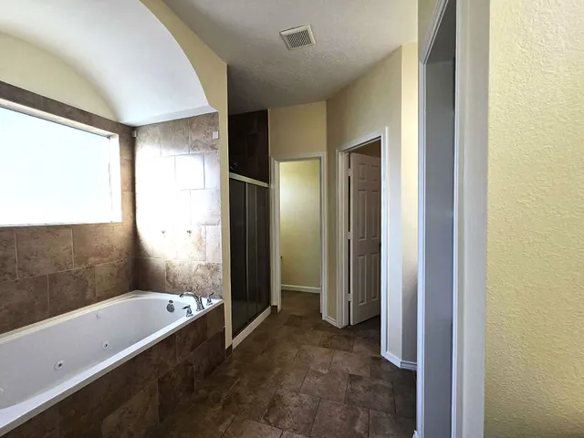 a view of a bathroom with a tub shower and sink