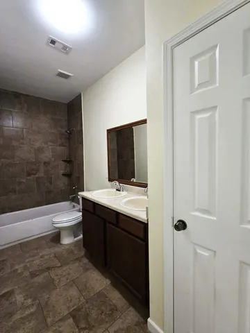 a bathroom with a toilet a sink and bathtub
