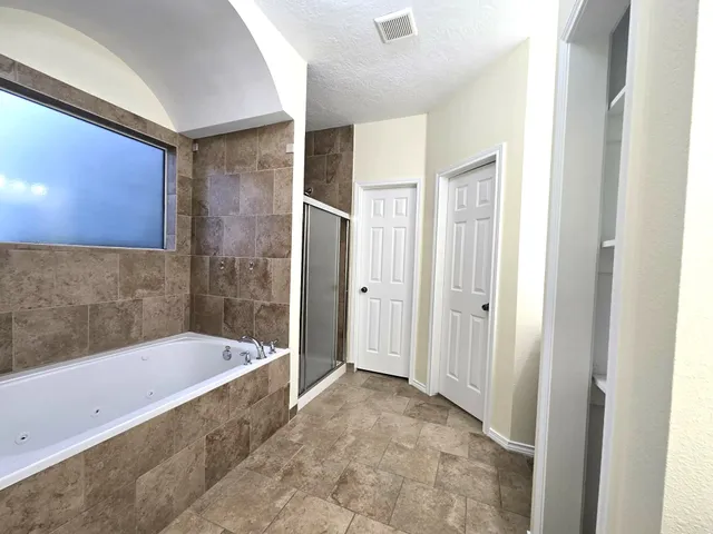 a bathroom with a bathtub and a shower