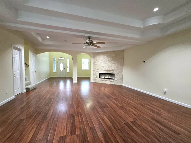 wooden floor in an empty room with a window