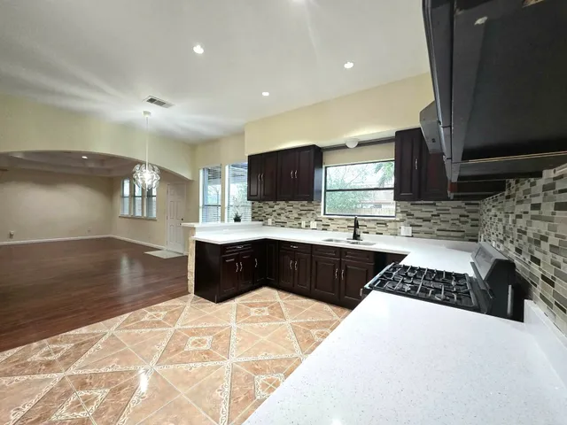 a kitchen with a sink stove and cabinets