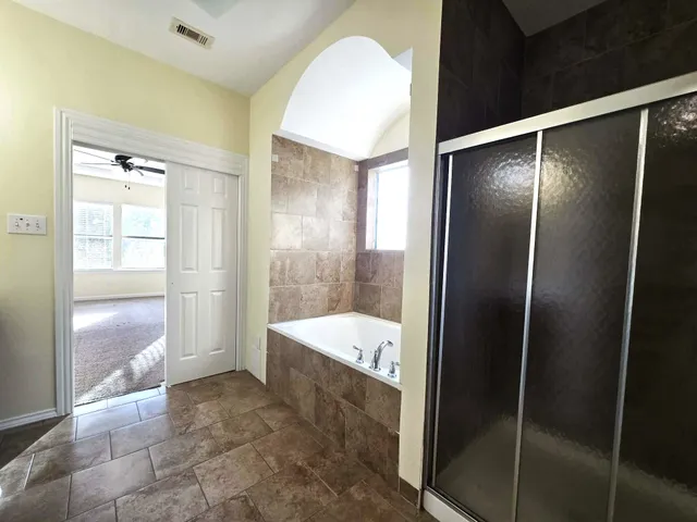 a bathroom with a tub and shower