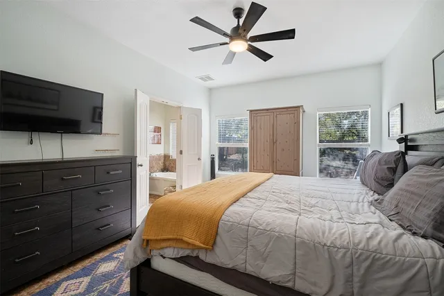 a bedroom with a bed and a flat screen tv