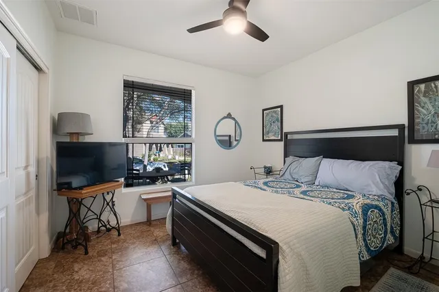 a bedroom with a bed and a flat screen tv