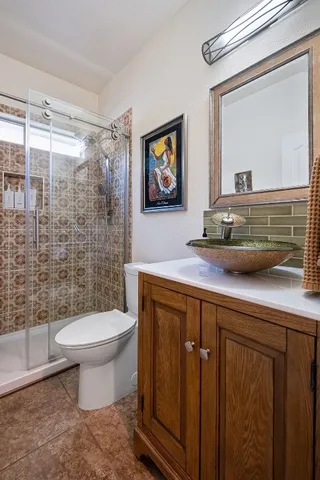 a bathroom with a toilet a sink and mirror