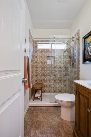 a bathroom with a toilet and a shower