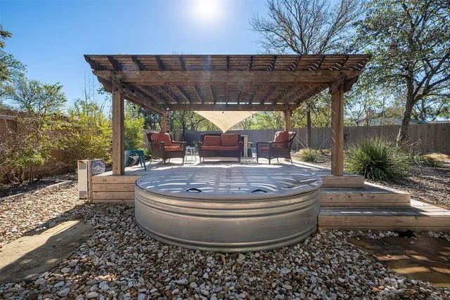 a view of a patio with table and chairs potted plants