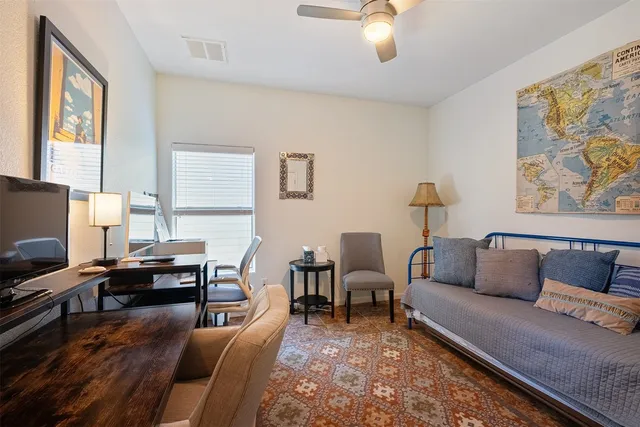 a living room with furniture and a flat screen tv with wooden floor