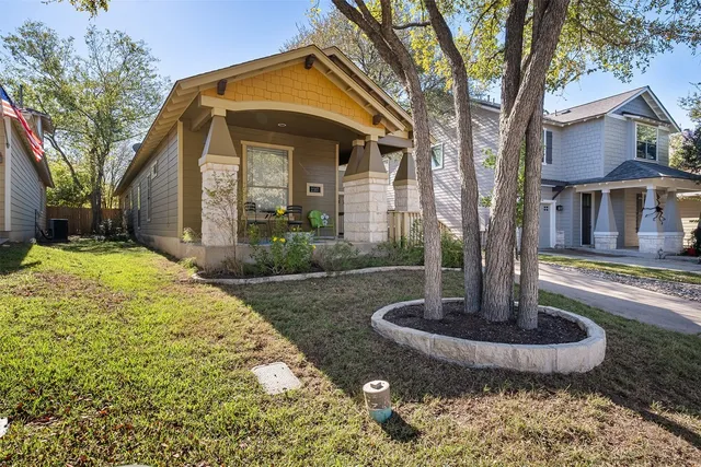 a front view of a house with a yard and porch