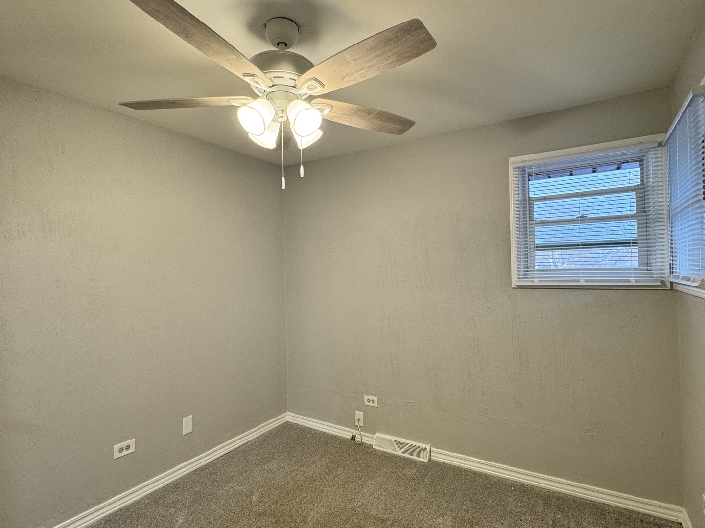 810 MacGregor Road Lockport, IL 60441 - Photo 19 of 25 an empty room with a window and a fan