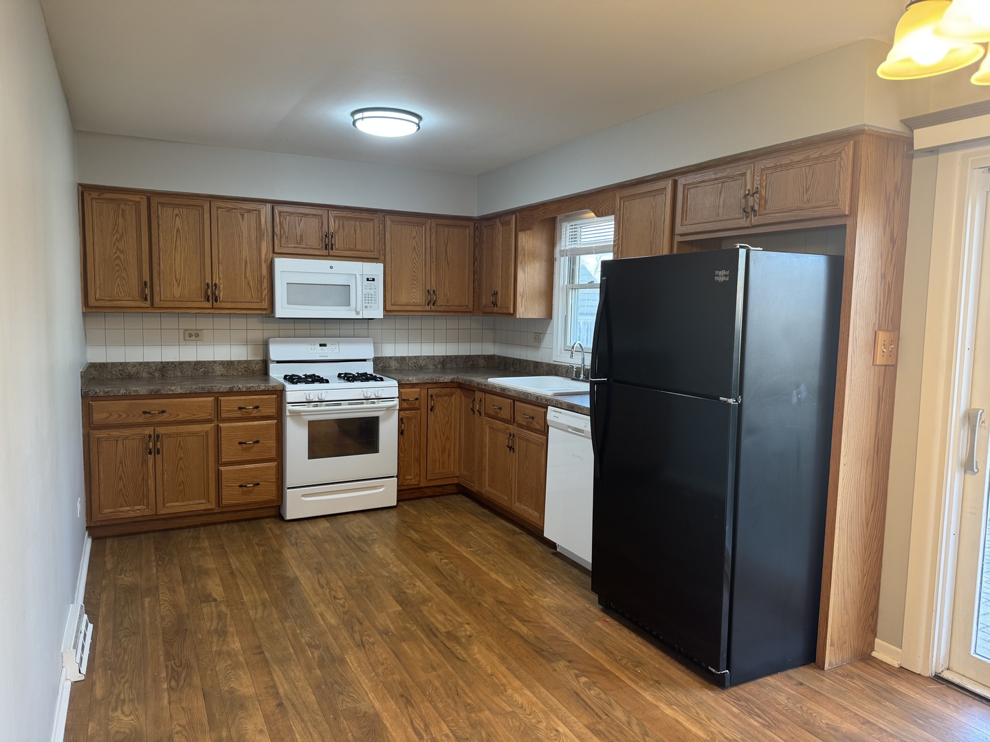 810 MacGregor Road Lockport, IL 60441 - Photo 5 of 25 a kitchen with a refrigerator stove and wooden cabinets