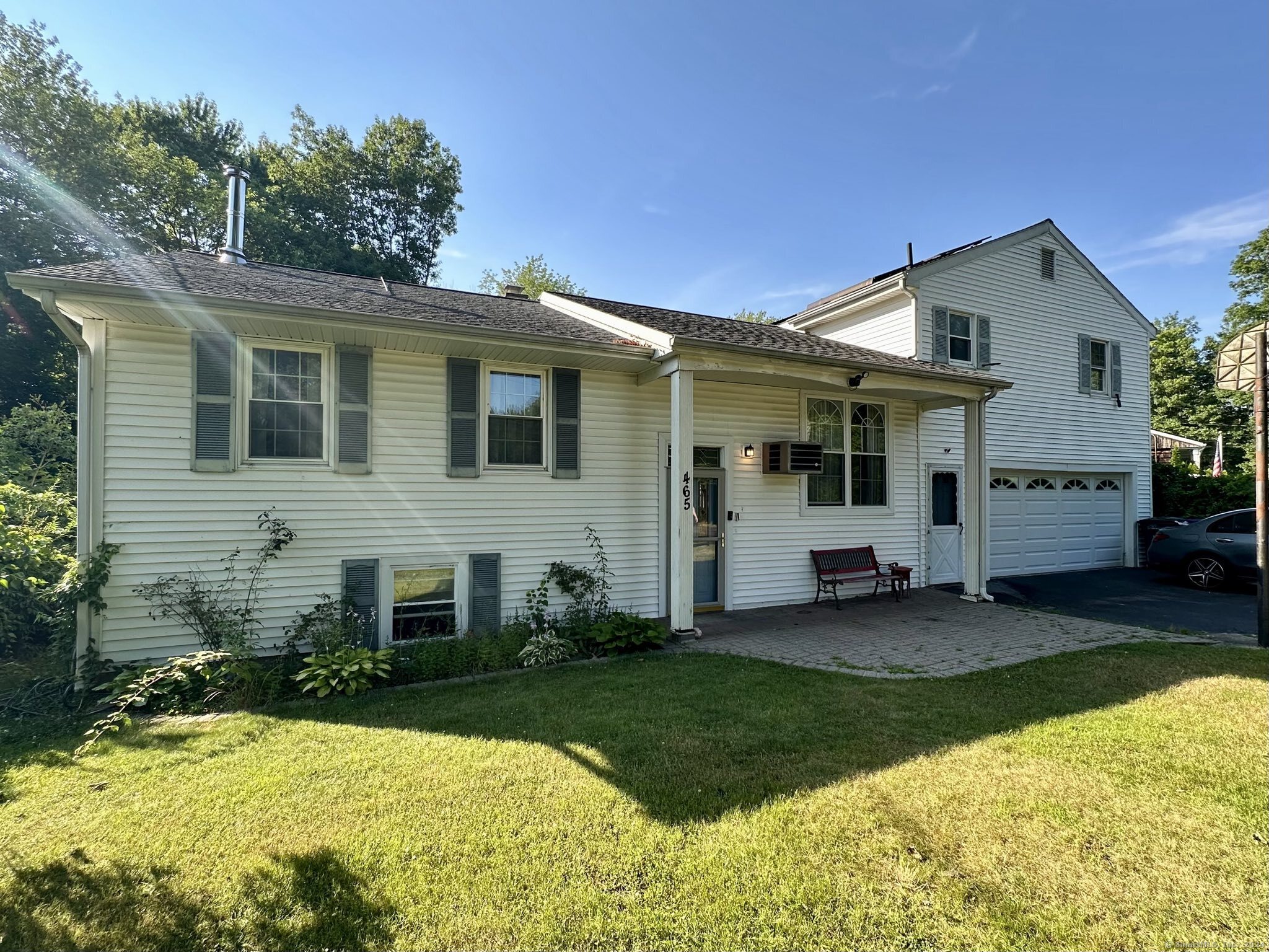 a view of a house with a yard patio and fire pit
