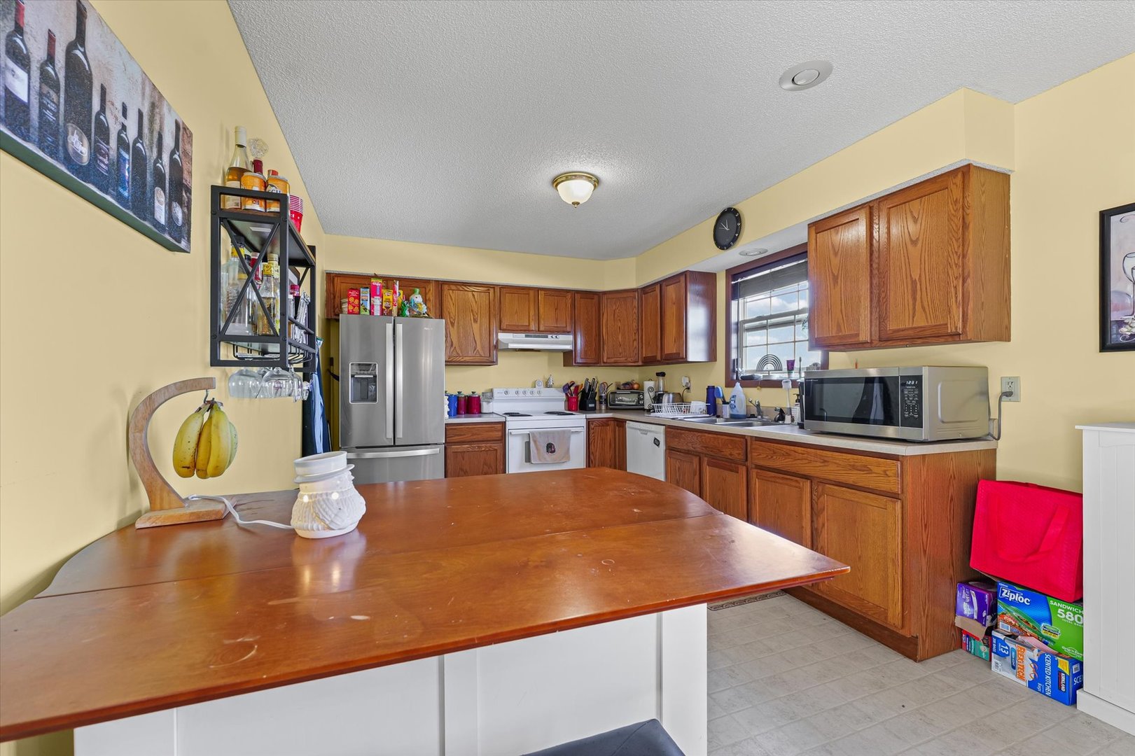 707 Country View Drive Philo, IL 61864 - Photo 12 of 28 a kitchen with stainless steel appliances granite countertop a refrigerator a stove top oven a sink dishwasher and cabinets with wooden floor