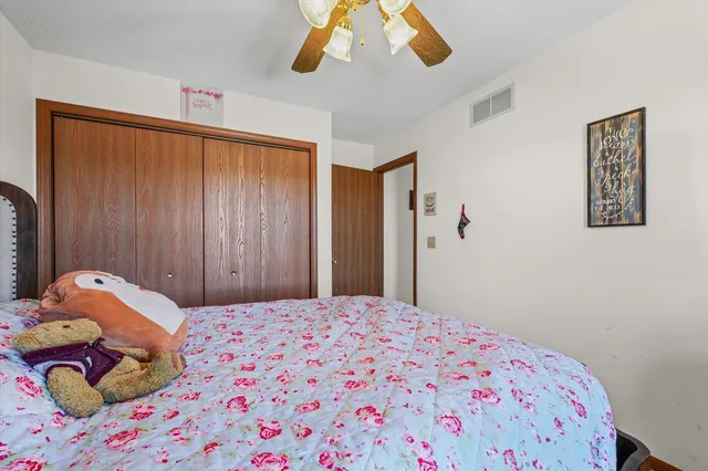 a bedroom with a bed and a dresser in it