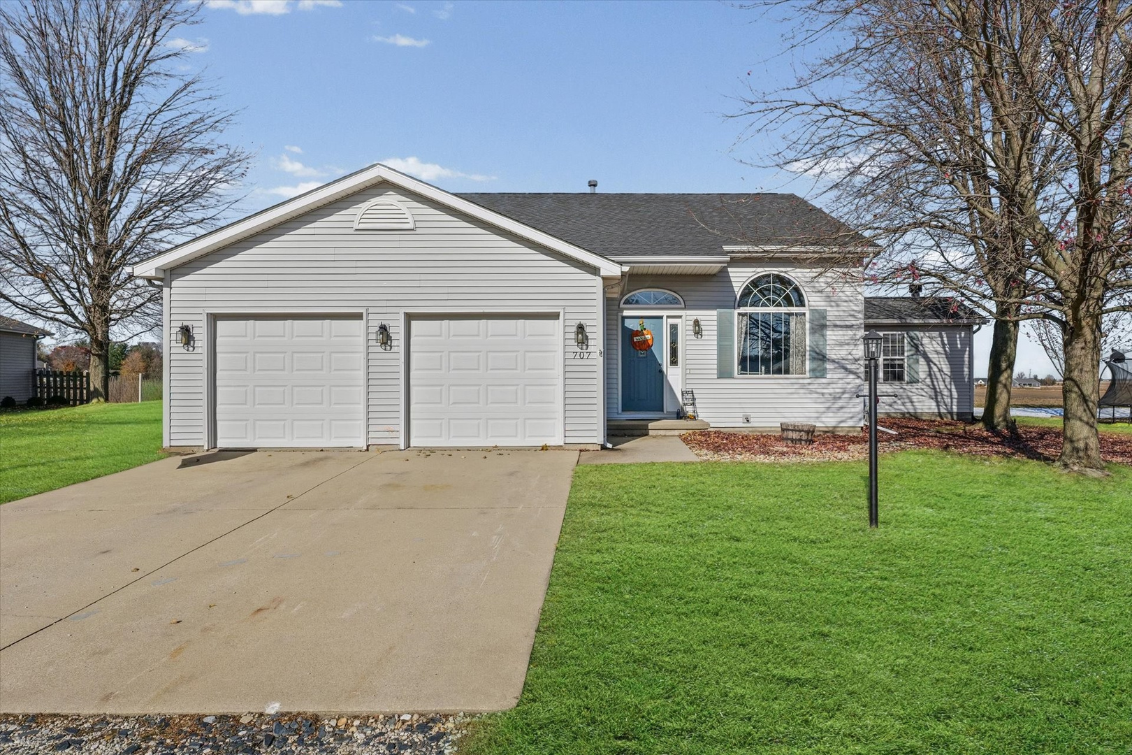 707 Country View Drive Philo, IL 61864 - Photo 2 of 28 a front view of a house with a yard and garage