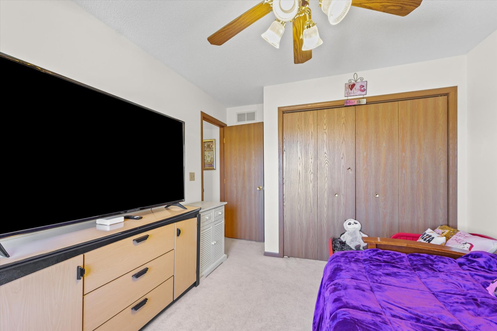 707 Country View Drive Philo, IL 61864 - Photo 23 of 28 a bedroom with a bed and a flat tv screen on dresser