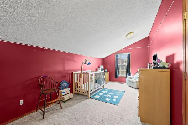 a bedroom with furniture and a baby crib