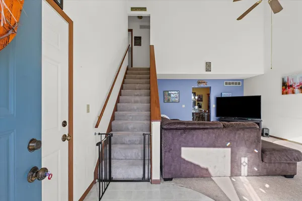 a view of a livingroom with furniture and staircase